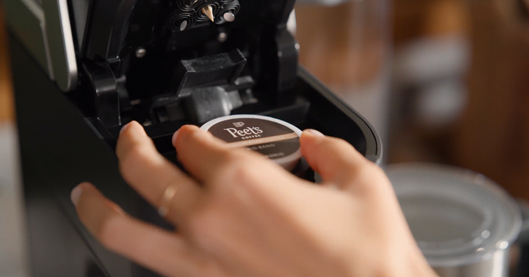 inserting k-cup pod in keurig coffee maker