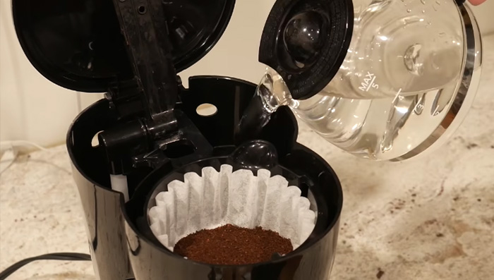 water pouring over coffee grounds